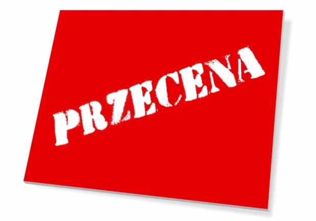 Czerwona prostokątna tabliczka informacyjna z białym, ukośnym napisem PRZECENA na białym tle