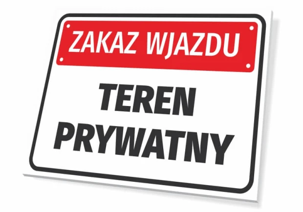 Prostokątna tabliczka z czerwonym paskiem i napisem Zakaz wjazdu - teren prywatny na białym tle