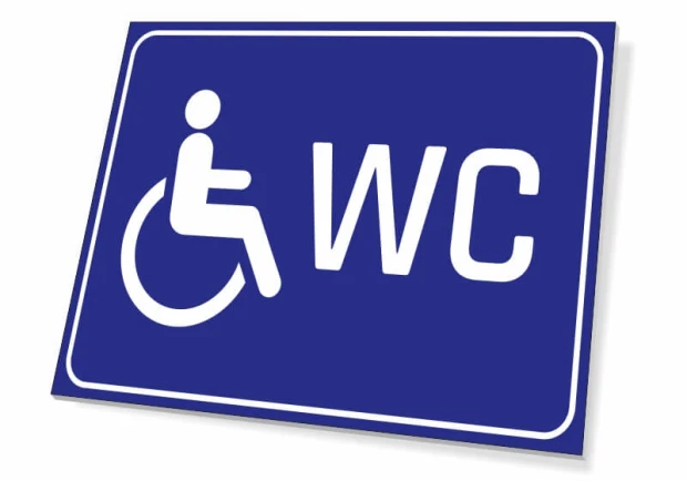 Tabliczka WC dla osób niepełnosprawnych - Wzór graficzny. Niebieskie tło z białym piktogramem osoby na wózku i napisem WC