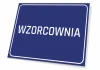 Tabliczka Wzorcownia - Wzór graficzny. Prosta, prostokątna tabliczka z białym napisem na niebieskim tle
