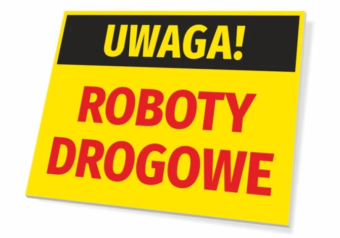 Tabliczka Uwaga Roboty drogowe - Wzór graficzny. Żółte tło z czarnym napisem Uwaga i czerwonymi literami Roboty Drogowe