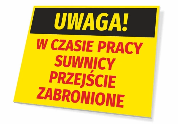 Żółta tabliczka ostrzegawcza BHP z napisem Uwaga! W czasie pracy suwnicy przejście zabronione