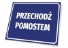 Tabliczka Przechodź pomostem - Wzór graficzny. Prosta, prostokątna tabliczka z białym tekstem na niebieskim tle