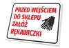 Tabliczka Przed wejściem do sklepu załóż rękawiczki - Wzór graficzny. Czerwony tekst na białym tle, obok dwa czarne