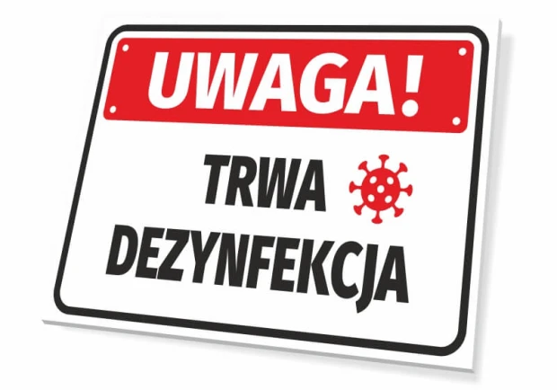 Tabliczka BHP z czerwonym ostrzeżeniem UWAGA! TRWA DEZYNFEKCJA oraz piktogramem wirusa na białym tle