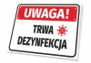 Tabliczka Uwaga Trwa dezynfekcja - Wzór graficzny. Prostokątna tabliczka z czerwonym tłem i białymi napisami