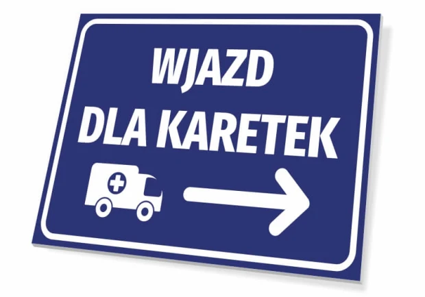Niebieska tabliczka informacyjna z białym napisem Wjazd dla karetek, piktogramem ambulansu i strzałką w prawo