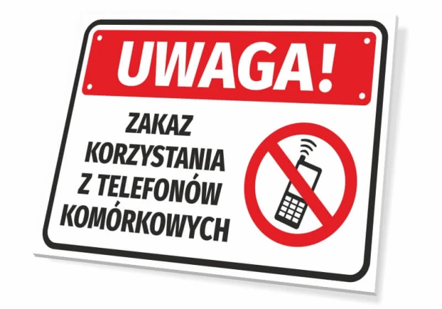 Tabliczka BHP z napisem Zakaz korzystania z telefonów komórkowych oraz czerwonym piktogramem zakazu na białym tle