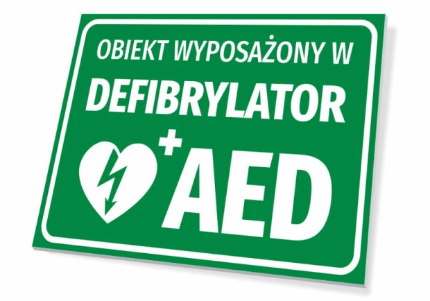 Zielona tabliczka BHP z napisem Obiekt wyposażony w defibrylator AED oraz piktogramem serca z błyskawicą
