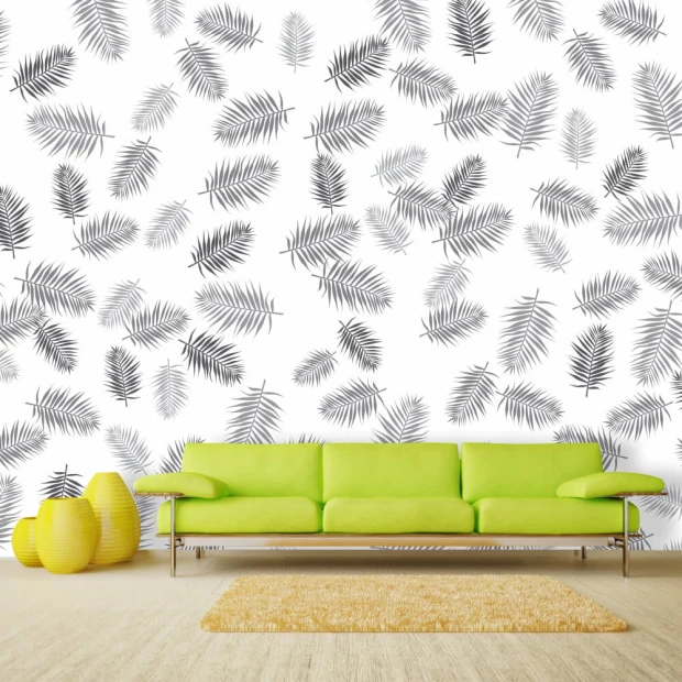 Tapeta na ścianę piórka 034 - Aranżacja w salonie. Zielona sofa na tle białej ściany z czarnymi liśćmi