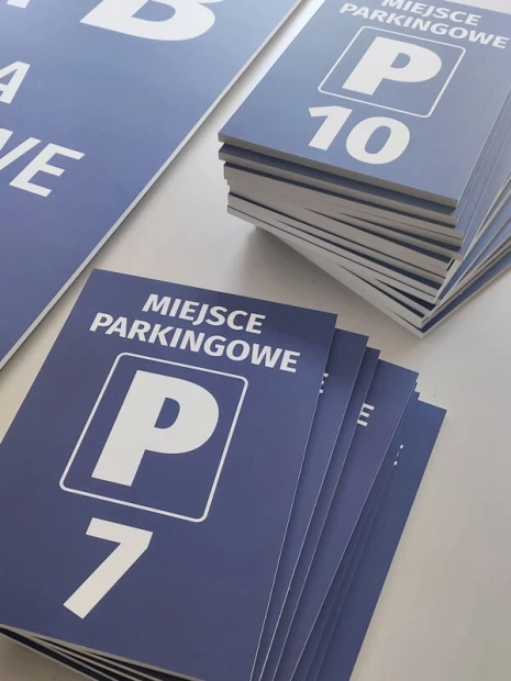 Zestaw niebieskich tabliczek z PCV z napisem Miejsce parkingowe P7 oraz P10 pokazujący grubość płyt