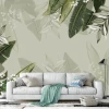 Tapeta Liście 097 - Aranżacja w salonie. Ściany w jasnym kolorze, sofa w jasnym odcieniu, zielone liście w tle