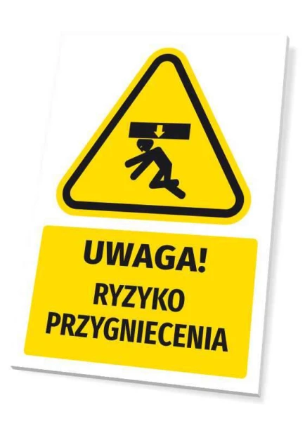 Żółta tabliczka ostrzegawcza BHP z czarnym piktogramem i napisem UWAGA! RYZYKO PRZYGNIECENIA na białym tle