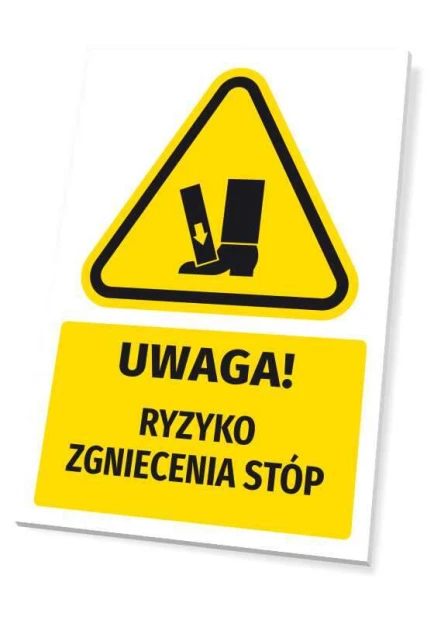 Żółta tabliczka ostrzegawcza BHP z czarnym piktogramem i napisem UWAGA! RYZYKO ZGNIECENIA STÓP na białym tle