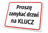 Tabliczka informacyjna: Proszę zamykać drzwi na klucz - Wzór graficzny. Prosta prostokątna forma z dużym tekstem. Czerwony