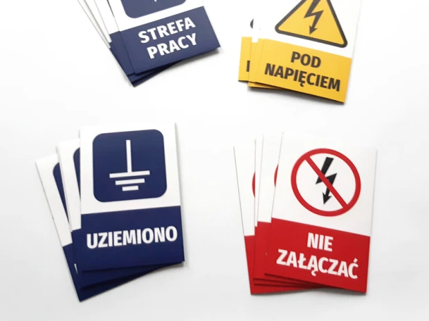 Prostokątne magnesy z przykładowym nadrukiem ostrzegawczym w postaci ułożonych stosów na białym tle