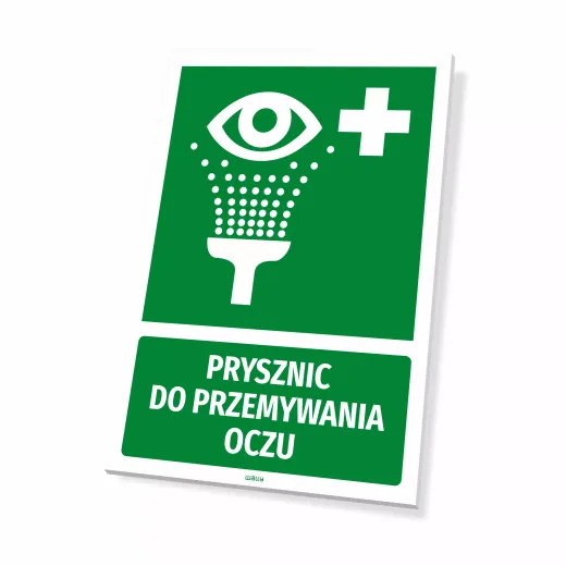 Zielona tabliczka BHP pierwsza pomoc z piktogramem i napisem Prysznic do przemywania oczu na białym tle