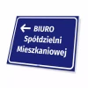 Tabliczka informacyjna: Biuro spółdzielni mieszkaniowej, strzałka w lewo